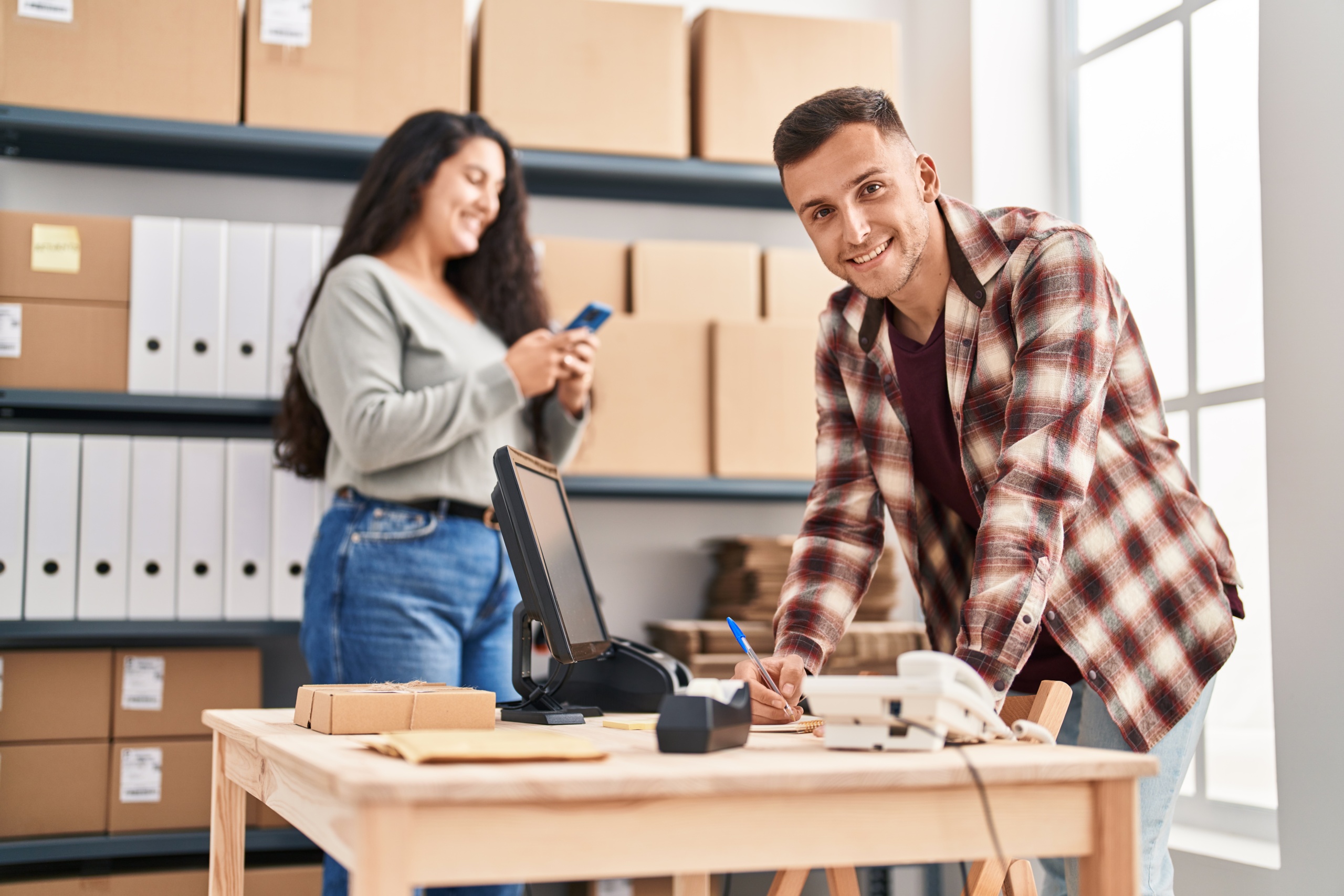 Man and woman working in a custom app development company